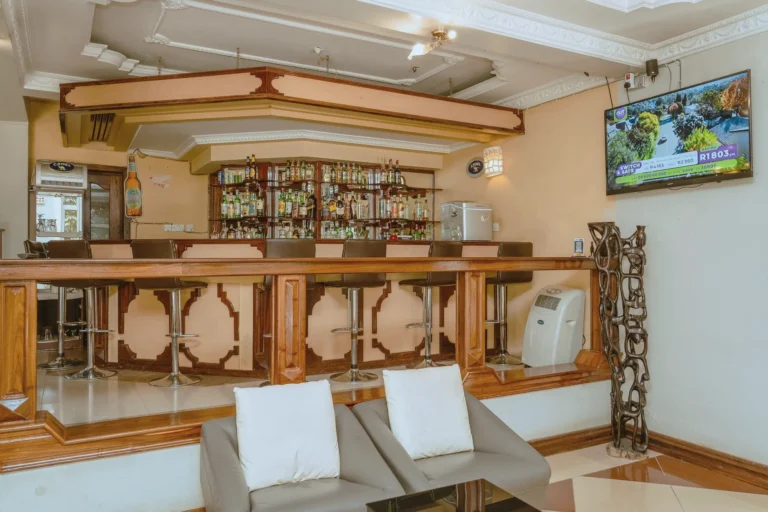 Lounge bar with sofas facing a carved timber bar