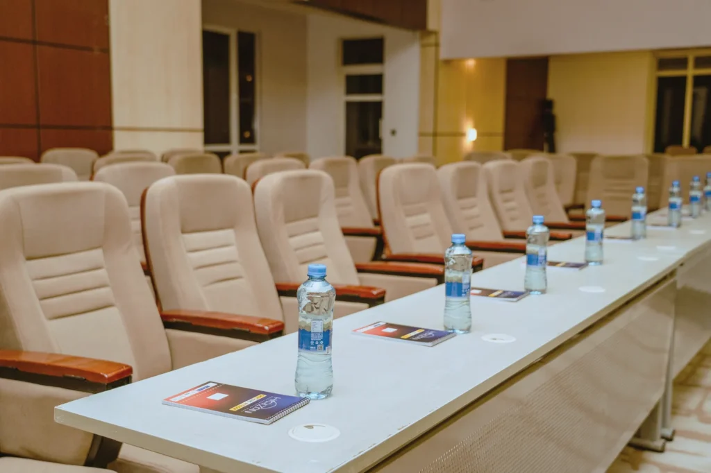 Meeting table set with water bottles and notepads