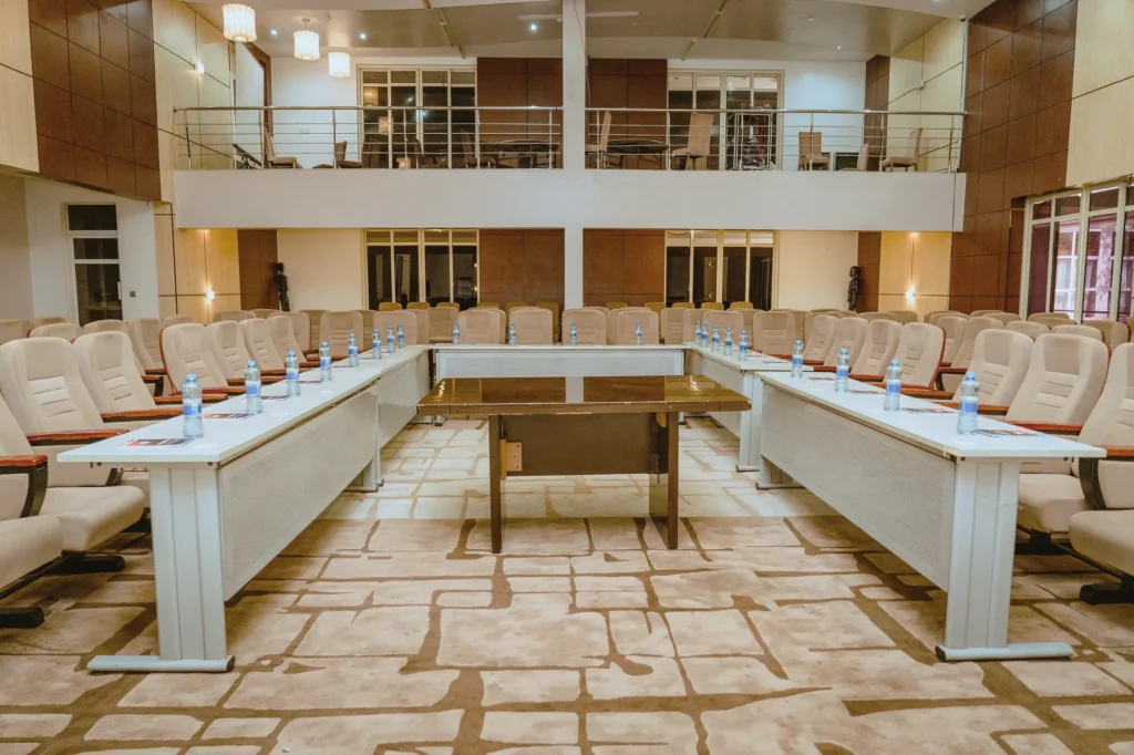 Conference tables arranged in a U beneath a gallery level
