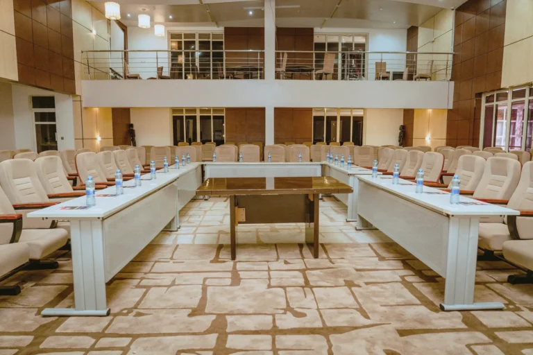 Conference tables arranged in a U beneath a gallery level