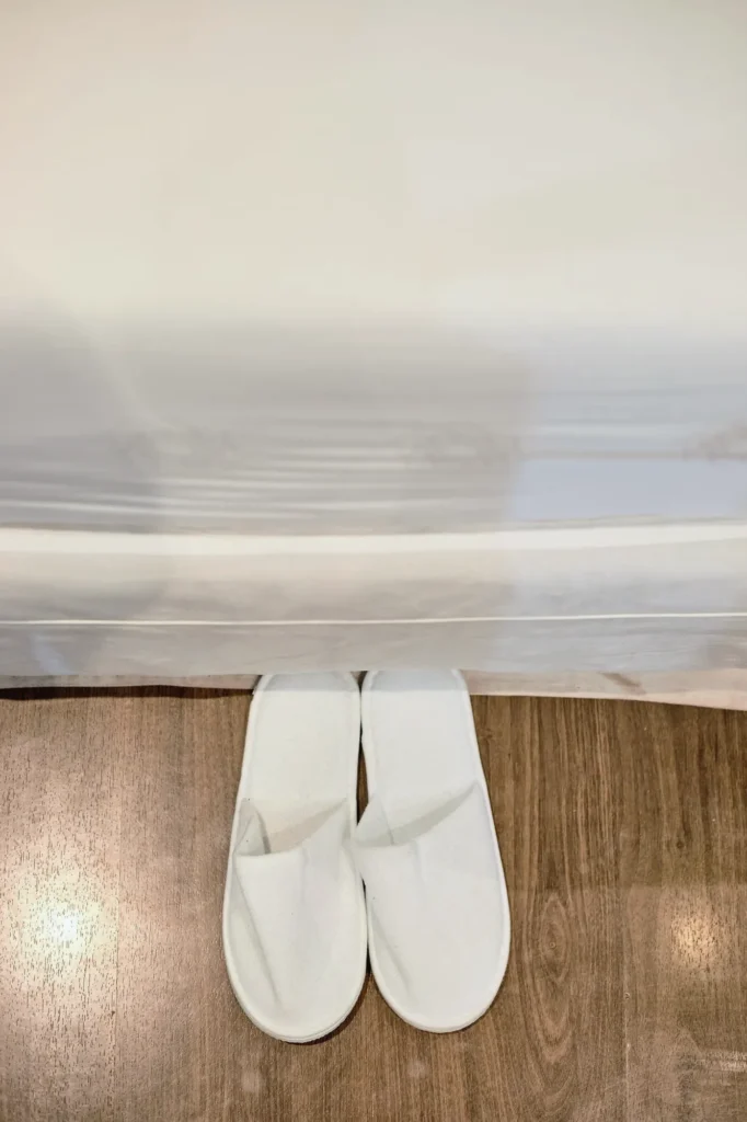 White guest slippers on a timber floor