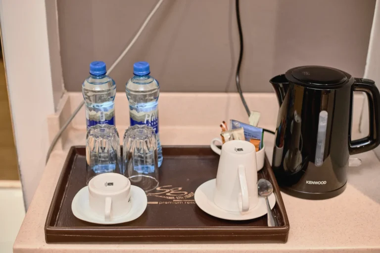 Tea tray with a kettle, cups and bottled water