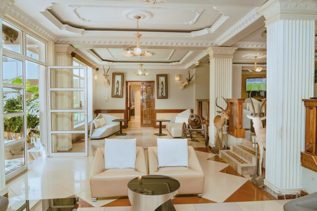 Lounge with cream sofas, chandeliers and mounted antelope horns