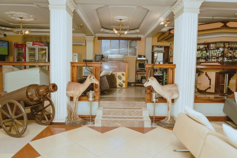 Lounge entrance with columns, a vintage cannon and antelope figures