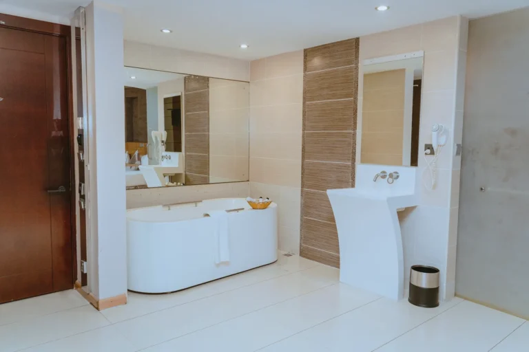 Suite bathroom with a freestanding tub and a sculpted white basin