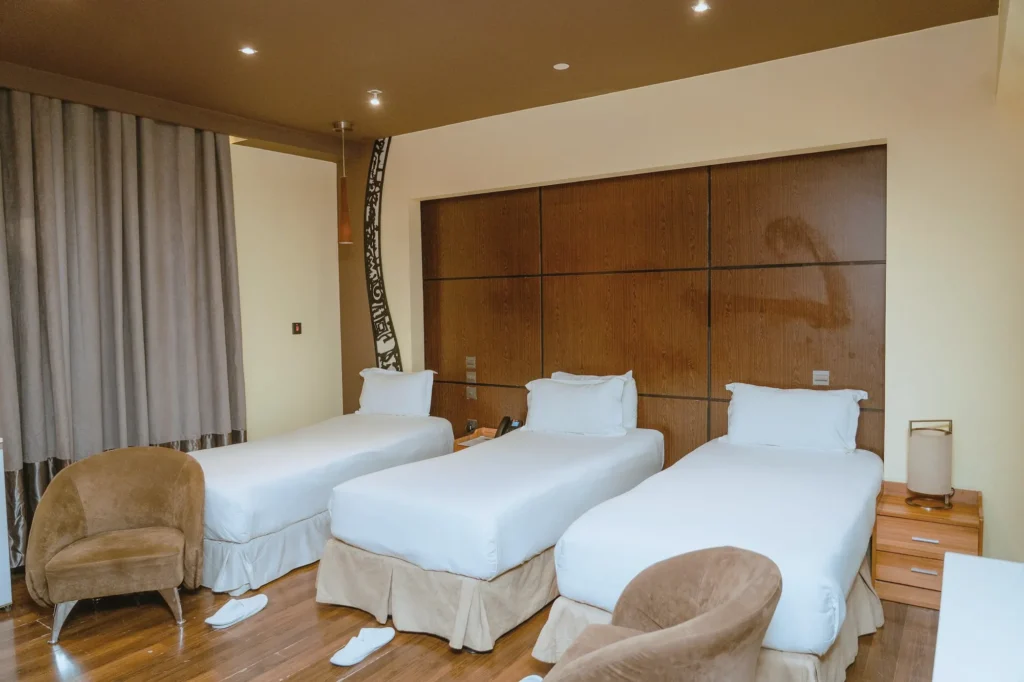 Triple Room with three single beds and warm timber floors